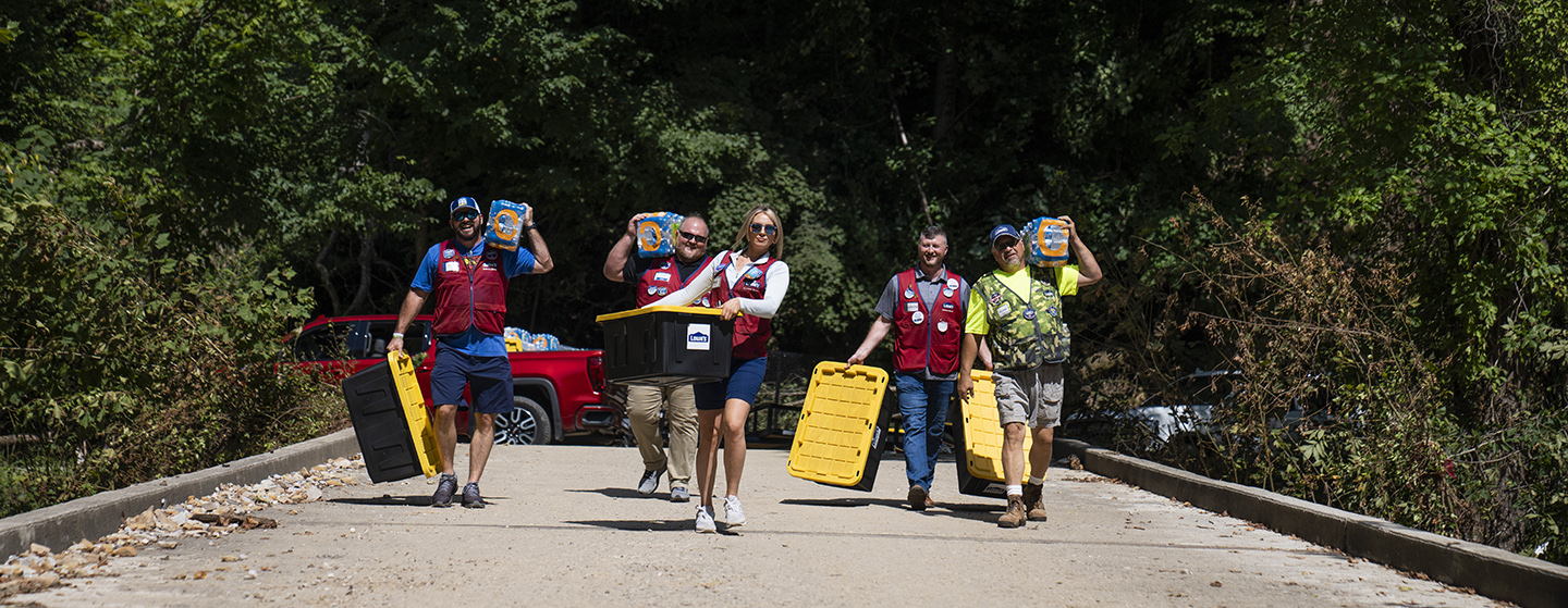 Lowe's associates carrying totes for disaster relief
