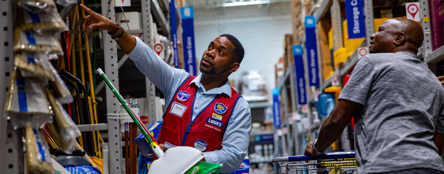 Lowe's associate in store aisle with customer