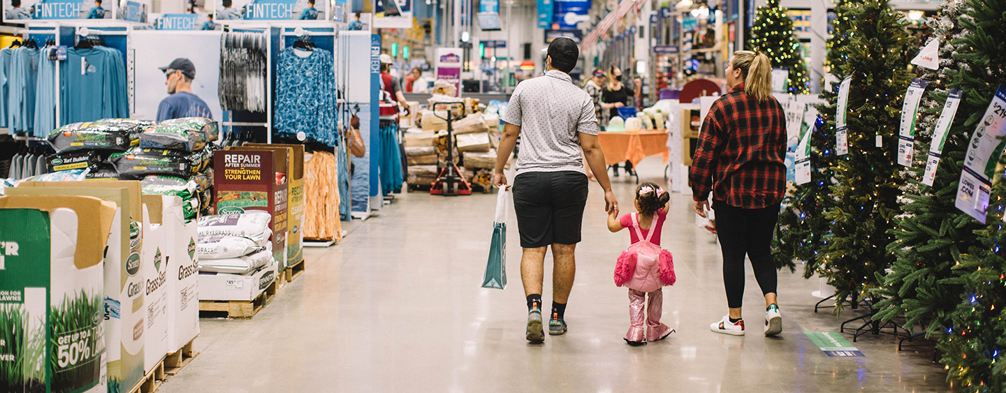 Parents walking with costumed child in Lowe's